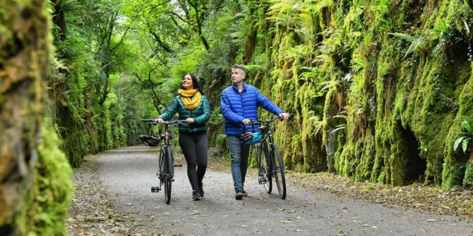 Couple cycling along the Waterford Greenway Irelands Ancient East Ireland