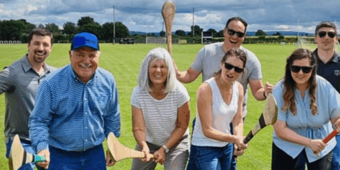 Visitors having fun and about to learn how to play hurling - ANCIENT EAST