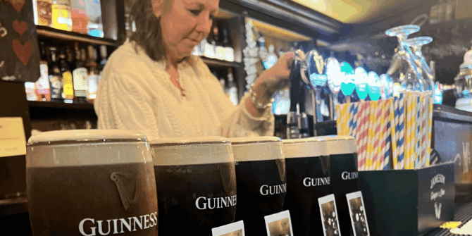 Concentrating on pouring Stout on tour, Galway city, Wild Atlantic Way